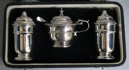 A cased George V three piece silver condiment set